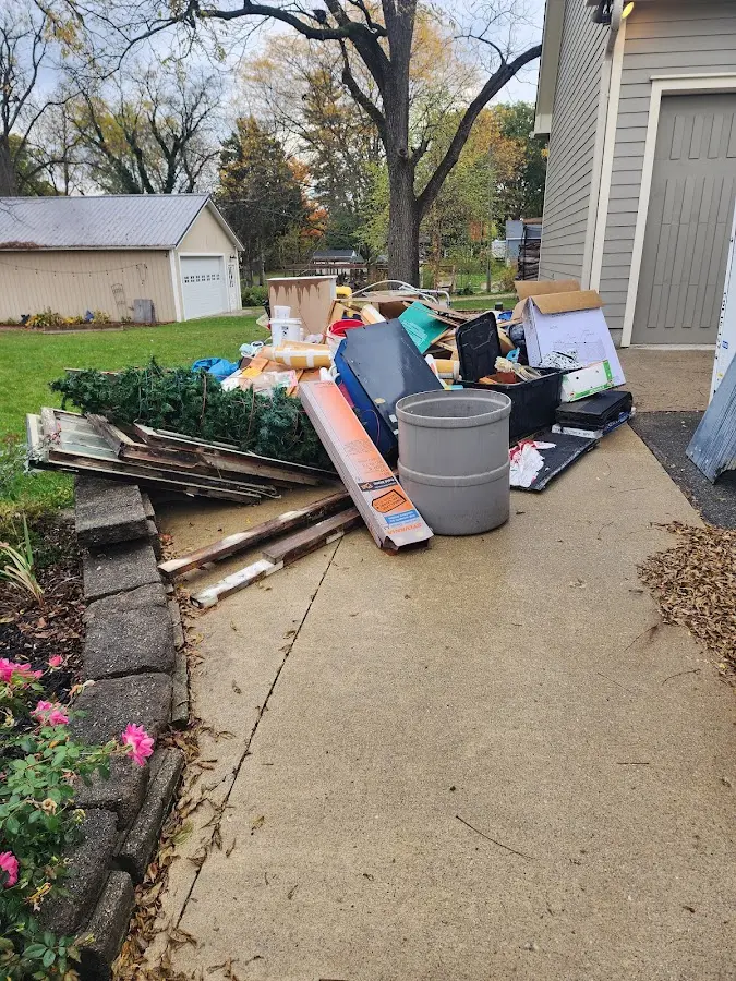 Dumpster being loaded with debris for Estate Cleanout Dumpster Rental in University of Virginia